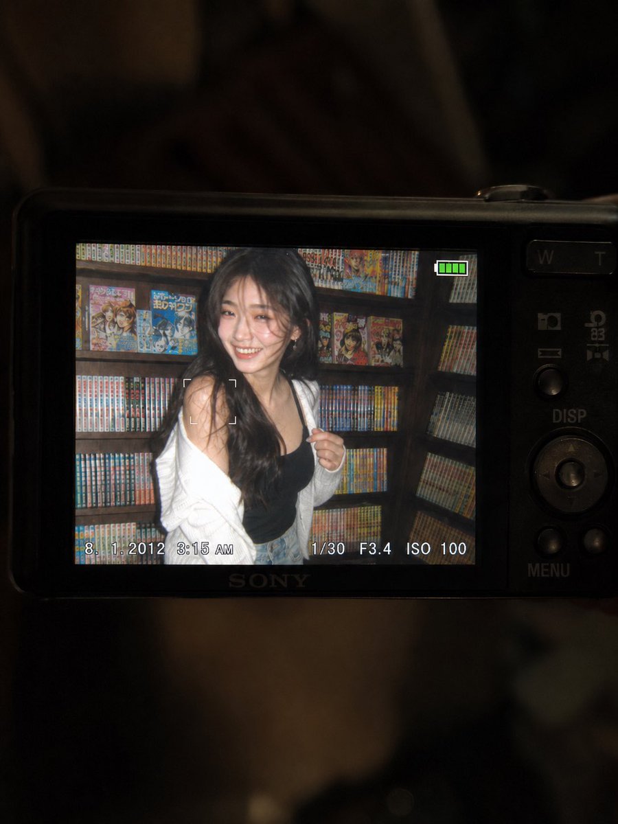 一张超精细的特写镜头：一台微型紧凑型数码相机的 LCD 屏幕在原本黑暗的室内房间中明亮发光。屏幕上是一张 2010 年代初期的随性傻瓜相机快照…, 图片 4