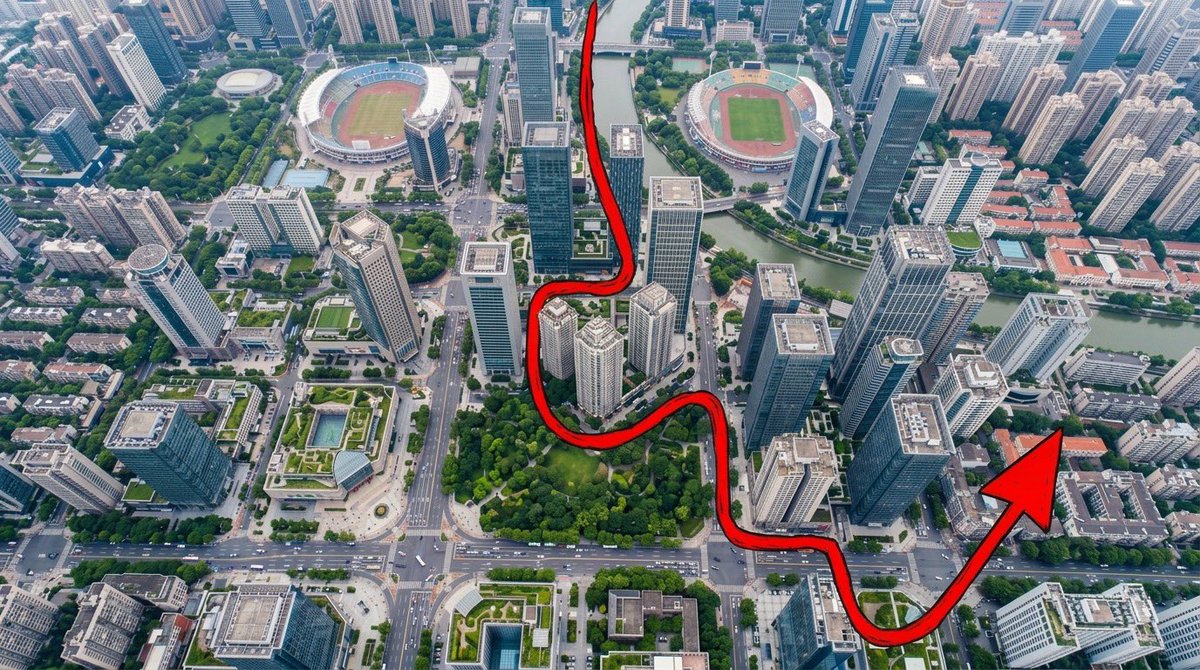 “一张从正上方拍摄的、写实风格的航拍无人机照片，呈现一座密集、充满活力的现代城市：摩天大楼鳞次栉比，城市街区排列有序，街道上布满小巧的车辆，建…, 图片 1