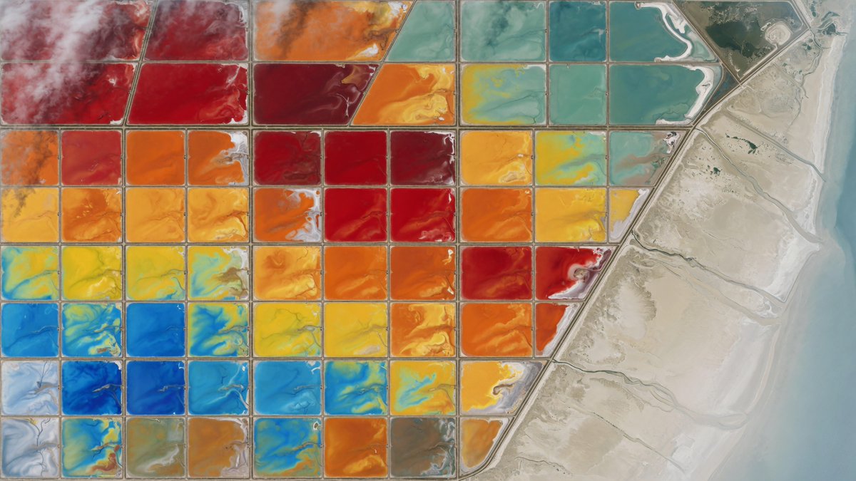 A breathtaking professional satellite-style aerial image of vibrant salt evapor…