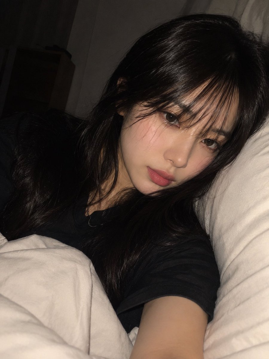 一张高度写实、亲密的夜间卧室自拍,照片中一位年轻成年东亚女性舒适地躺在床上,以一种随意、自发的智能手机拍摄方式捕捉,拍摄于即将入睡的时刻。请使…, 图片 1