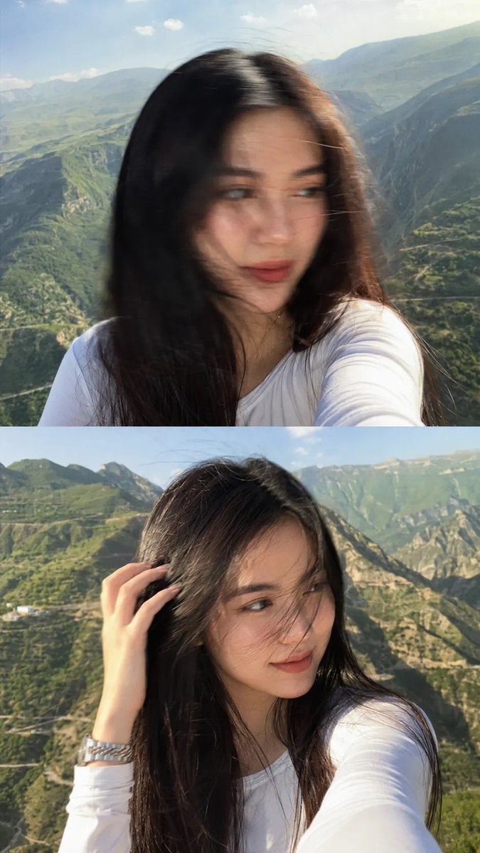 一张梦幻电影感的自拍照：一位美丽的年轻女子站在山顶观景点，长发笔直乌黑，拍摄于黄金时刻。她身穿一件修身白色长袖上衣，佩戴一只银色金属腕表。微风…, 图片 2