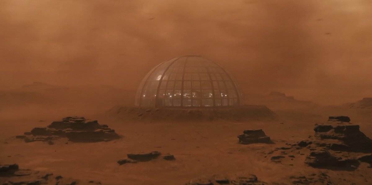 A human colony on Mars sits beneath a transparent dome during a violent red dus…