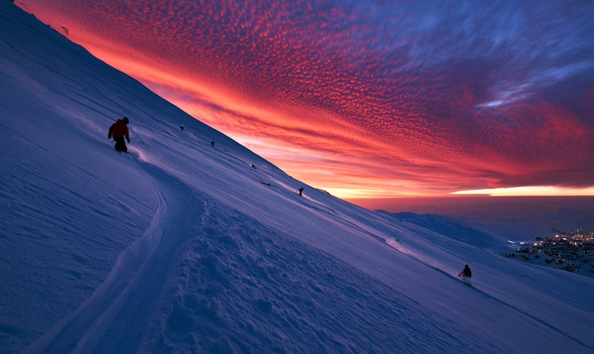 Use @[environment ref] for the steep alpine slope, crimson sky, blue snow shado…