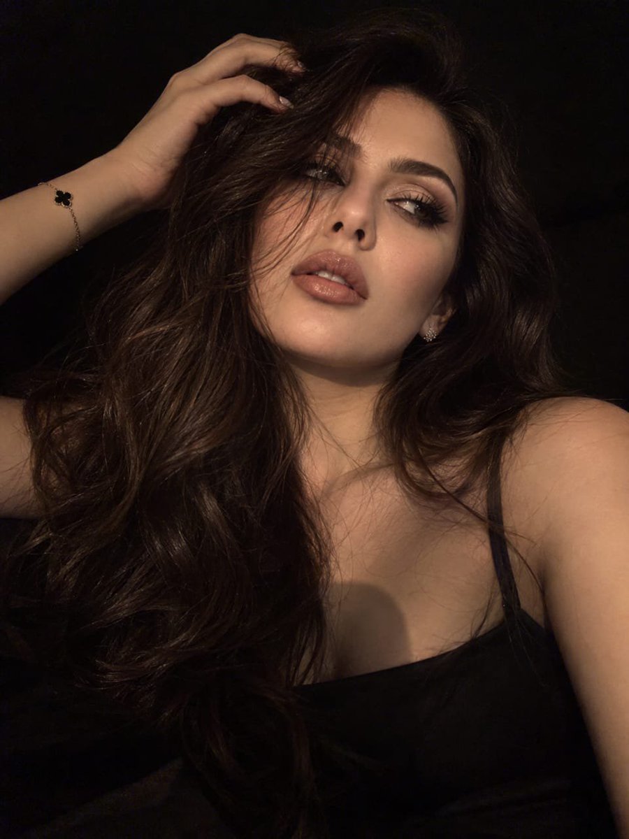 Keep the girl’s appearance from the reference. A realistic night selfie on the …