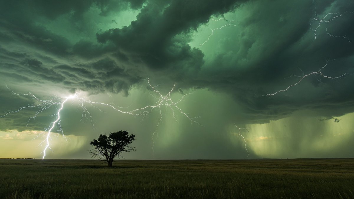 A breathtaking professional earth-science photograph of multiple lightning bolt…